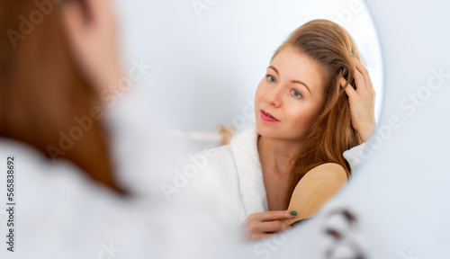 woman brushing her red hair