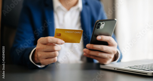 businessman hand using smart phone, tablet payments and holding credit card online shopping, omni channel, digital tablet docking keyboard computer