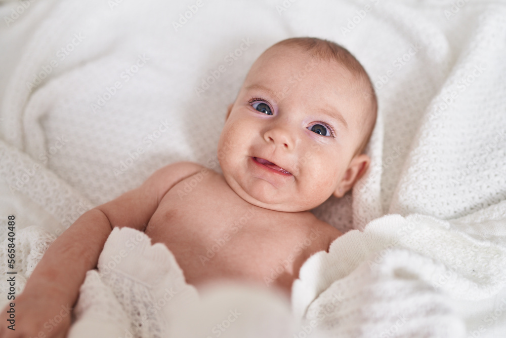 Adorable caucasian baby smiling confident lying on bed at bedroom Adorable caucasian baby smiling confident lying on bed at bedroom