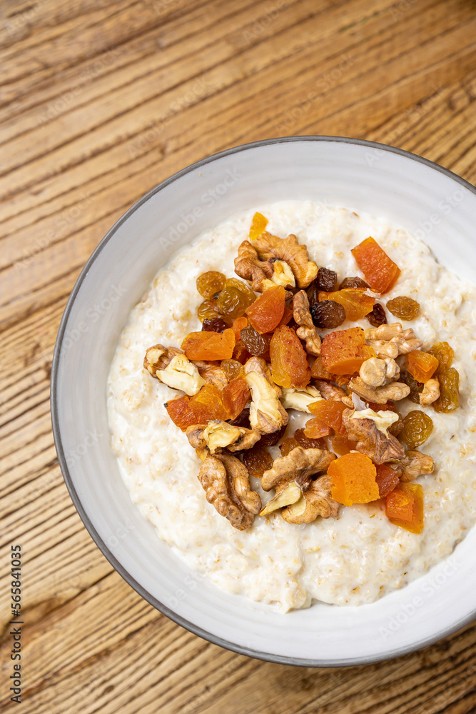 a delicious breakfast on a plate prepared in the restaurant. oatmeal with candied fruit and nuts
a delicious breakfast on a plate prepared in the restaurant. oatmeal with candied fruit and nuts