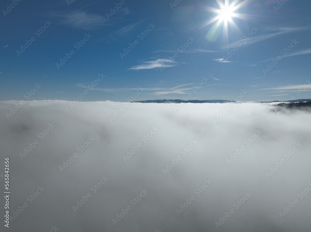 Obraz premium Aerial View. Flying over the high mountains in beautiful clouds. Aerial Drone camera shot. Air pollution clouds over Sarajevo in Bosnia and Herzegovina. 
