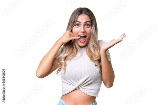 Young Uruguayan woman over isolated background making phone gesture and doubting