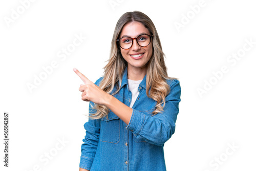 Young Uruguayan woman over isolated background pointing to the side to present a product