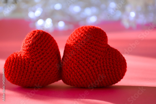 Valentine's day. holiday of lovers, love. viva magenta. background for the design. two knitted hearts.