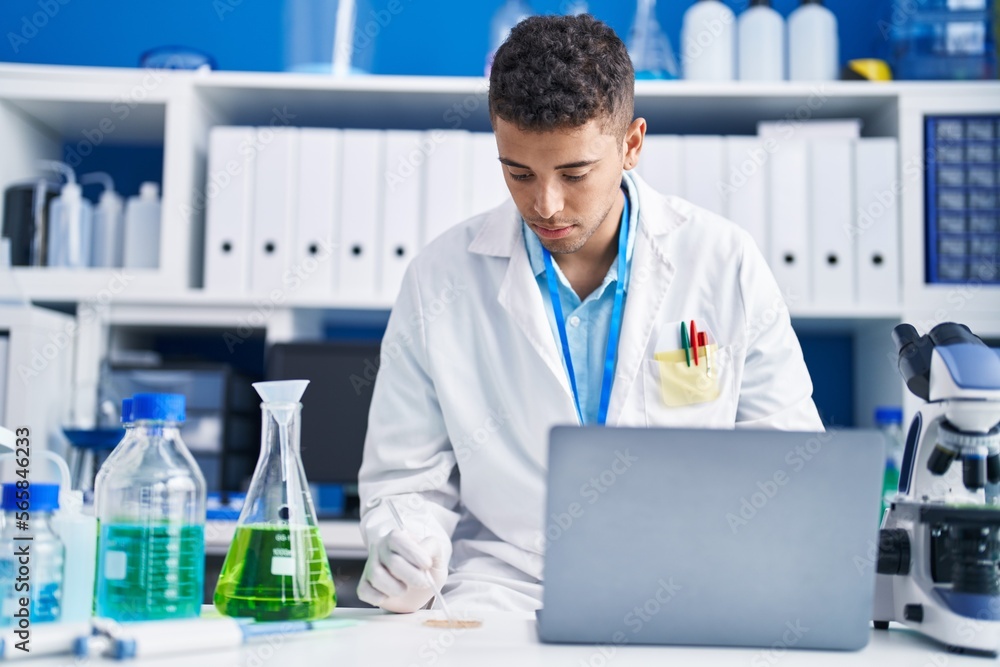 African american man scientist using laptop working at laboratory African american man scientist using laptop working at laboratory