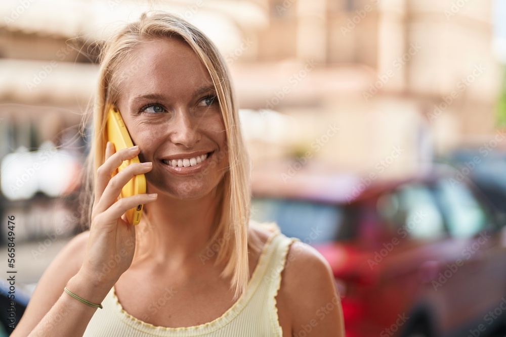 Young blonde woman smiling confident talking on the smartphone at street Young blonde woman smiling confident talking on the smartphone at street
