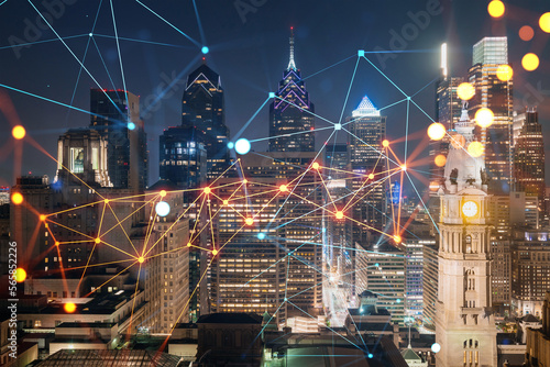Aerial panoramic cityscape of Philadelphia financial downtown at night time, Pennsylvania, USA. Glowing Social media icons. The concept of networking and establishing new connections between people