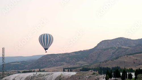 Aerial view hot air balloon flight over Natural travertine pools and terraces in Pamukkale early in the morning sunrse, Pamukkale geothermal springs, travertine terraces, ancient city of Hierapolis. photo