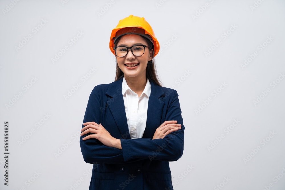 Portrait of Asian female engineer wearing hard hat with her arms crossed isolated on grey background. Portrait of Asian female engineer wearing hard hat with her arms crossed isolated on grey background.