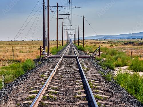 Lonely Railway. Train travel and transportation. Concept of distance and direction. © Susana