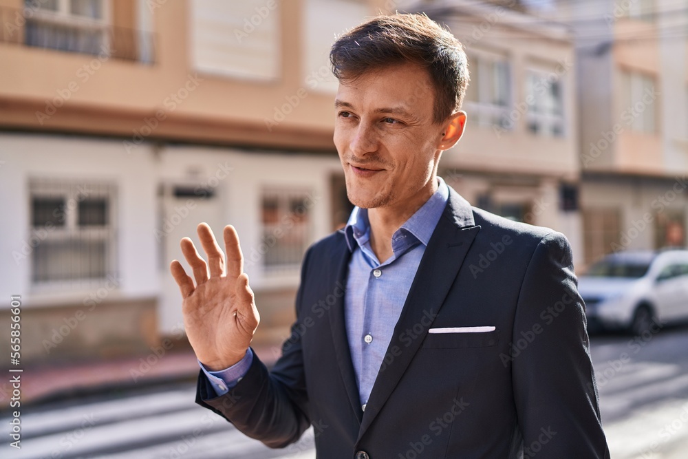 Young man business worker smiling confident saying hello at street Young man business worker smiling confident saying hello at street