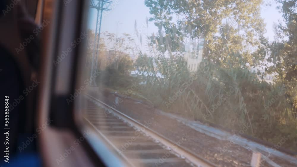 View from inside of driving train, local commute riding railways to approach train station, view from the window of train in motion, arriving at station platform View from inside of driving train, local commute riding railways to approach train station, view from the window of train in motion, arriving at station platform