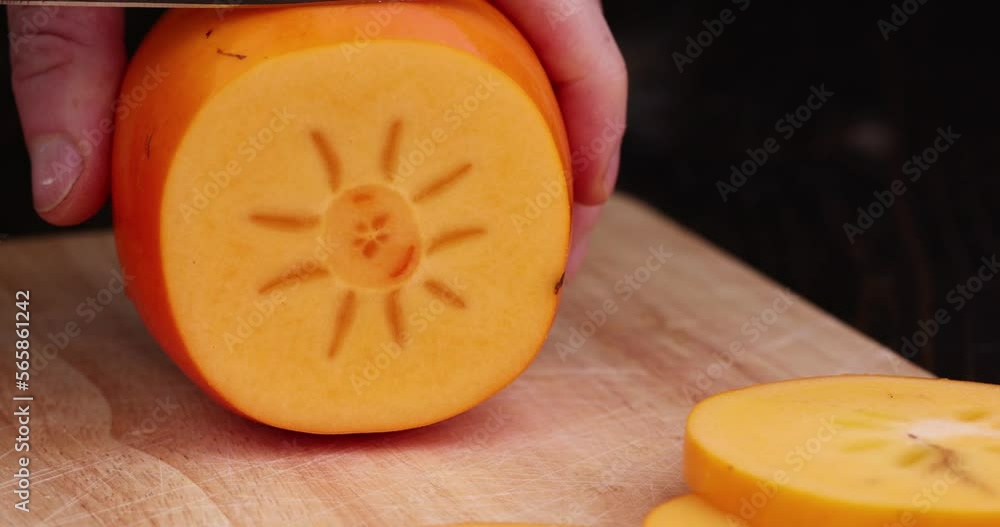 Half-cut ripe and sweet persimmon, details of the pulp of ripe persimmon Half-cut ripe and sweet persimmon, details of the pulp of ripe persimmon