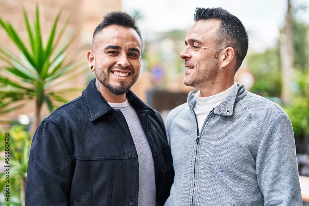 Two men couple smiling confident standing together at street Two men couple smiling confident standing together at street