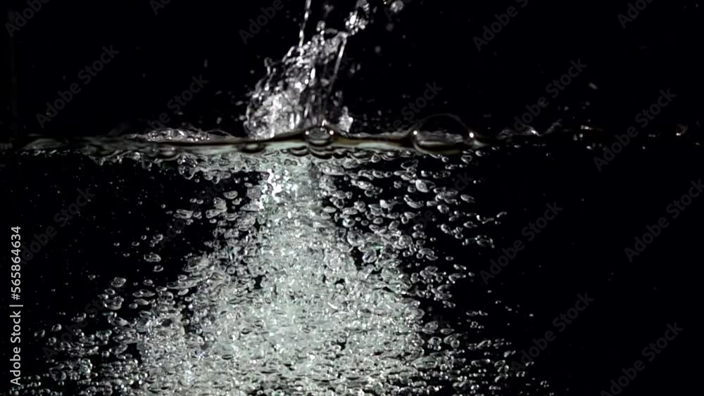 Super slow-motion shot of water splash against black. Shooted with high speed cinema camera at 1000fps Super slow-motion shot of water splash against black. Shooted with high speed cinema camera at 1000fps