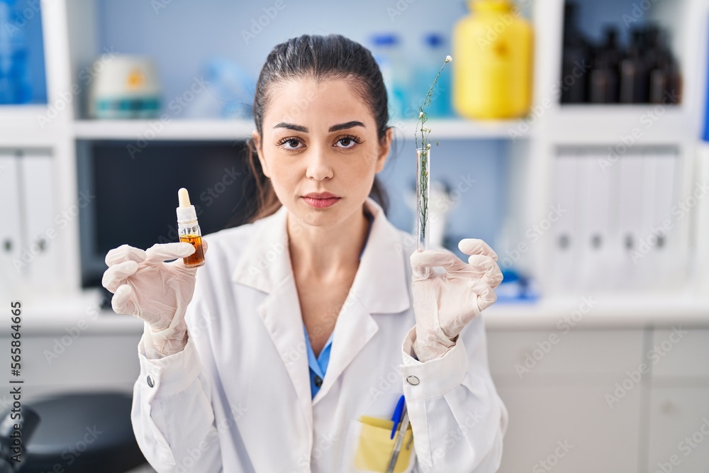 Young woman doing weed oil extraction at laboratory relaxed with serious expression on face. simple and natural looking at the camera. Young woman doing weed oil extraction at laboratory relaxed with serious expression on face. simple and natural looking at the camera.