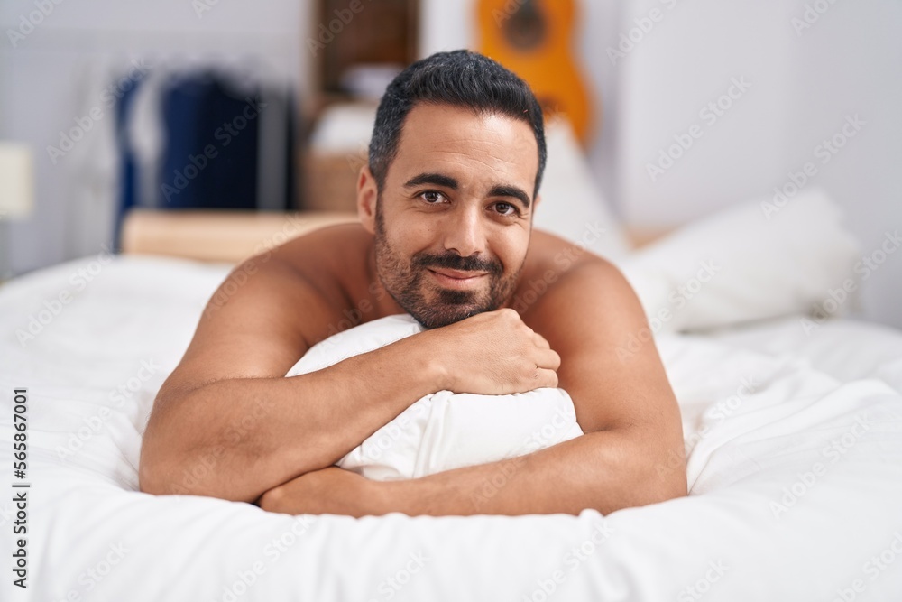 Young hispanic man smiling confident lying on bed at bedroom Young hispanic man smiling confident lying on bed at bedroom
