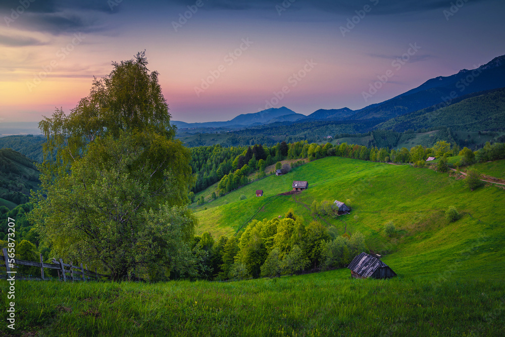 Countryside landscape and wooden huts on the slope, Transylvania, Romania