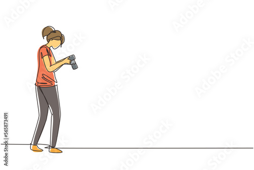 Single one line drawing woman photographers or paparazzi taking photo with digital cameras with angles. Girl Journalists or reporters checking pictures. Continuous line draw design vector illustration