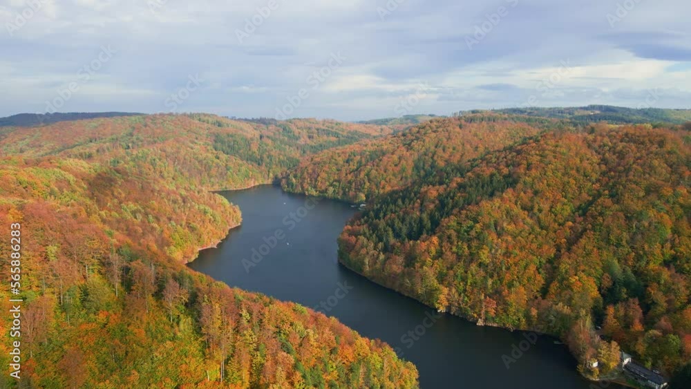 Aerial top view of amazing autumn landscape with mountains covered with forest and river. Beautiful nature landscape at fall season Aerial top view of amazing autumn landscape with mountains covered with forest and river. Beautiful nature landscape at fall season