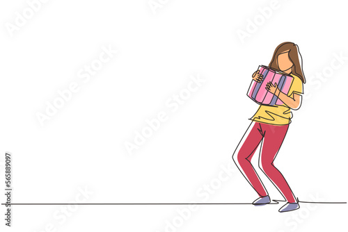 Single one line drawing young beautiful girl hugging gift box. Cheerful woman carrying a heavy gift box. Bonus or special offer. Present of celebration. Continuous line draw design vector illustration