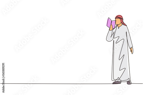 Single continuous line drawing Arabian guy standing and reads book that holds in one hand. Young man love to read. Male students with open books in hands. One line draw design vector illustration