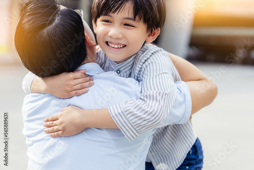 Parent and child being friend Happy son and father having fun, Son hug father and smiling together spending time at outdoor in a city together Kid give love to his parent Single father concept