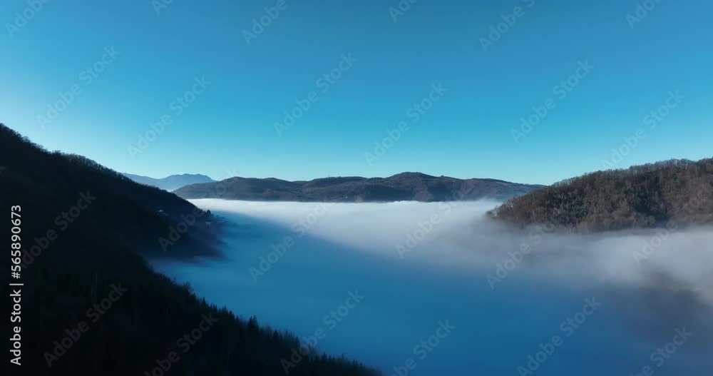 Aerial View. Flying over the high mountains in beautiful clouds. Aerial Drone camera shot. Air pollution clouds over Sarajevo in Bosnia and Herzegovina. Aerial View. Flying over the high mountains in beautiful clouds. Aerial Drone camera shot. Air pollution clouds over Sarajevo in Bosnia and Herzegovina.