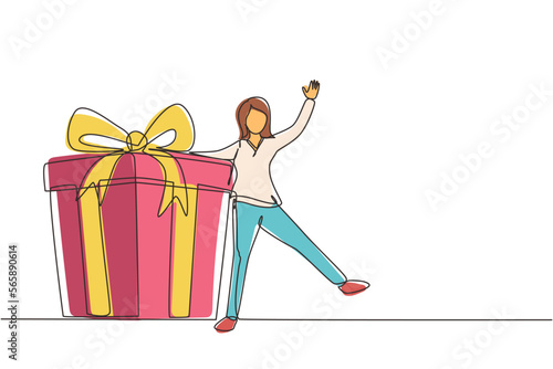 Single continuous line drawing loyalty program for regular clients. Businesswoman holds big gift box. Gift for holiday. Happy girl standing next to large gift. One line draw design vector illustration