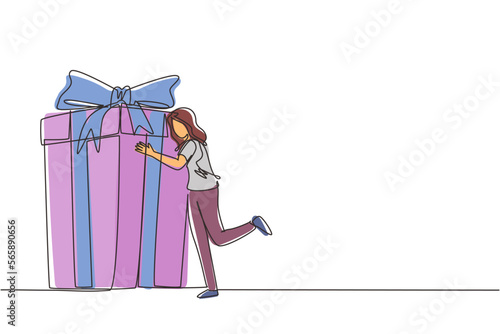 Single one line drawing girl hugging huge birthday gift. Young satisfied woman standing near wrapped birthday gift box with bow. Present, birthday. Continuous line draw design vector illustration