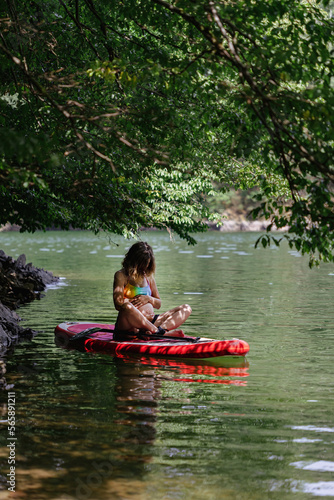 pregnant woman rides a sup under the sun's rays, a healthy lifestyle