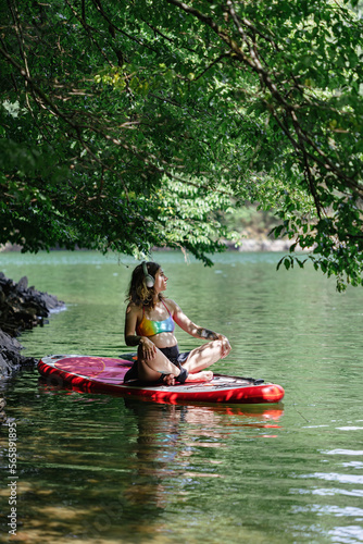 pregnant woman rides a sup under the sun's rays, a healthy lifestyle