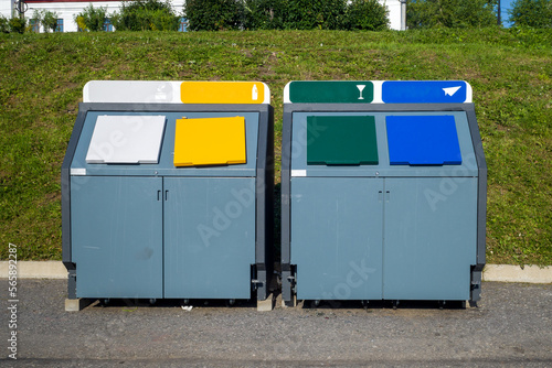 multicolored metal tanks for separate garbage. natural hard light © Dmitry