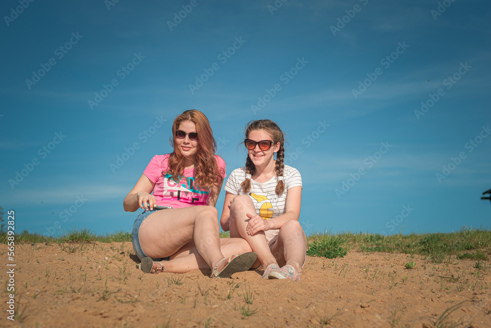 Portrait of young beautiful two girlfriends in summer outdoors. Portrait of young beautiful two girlfriends in summer outdoors.