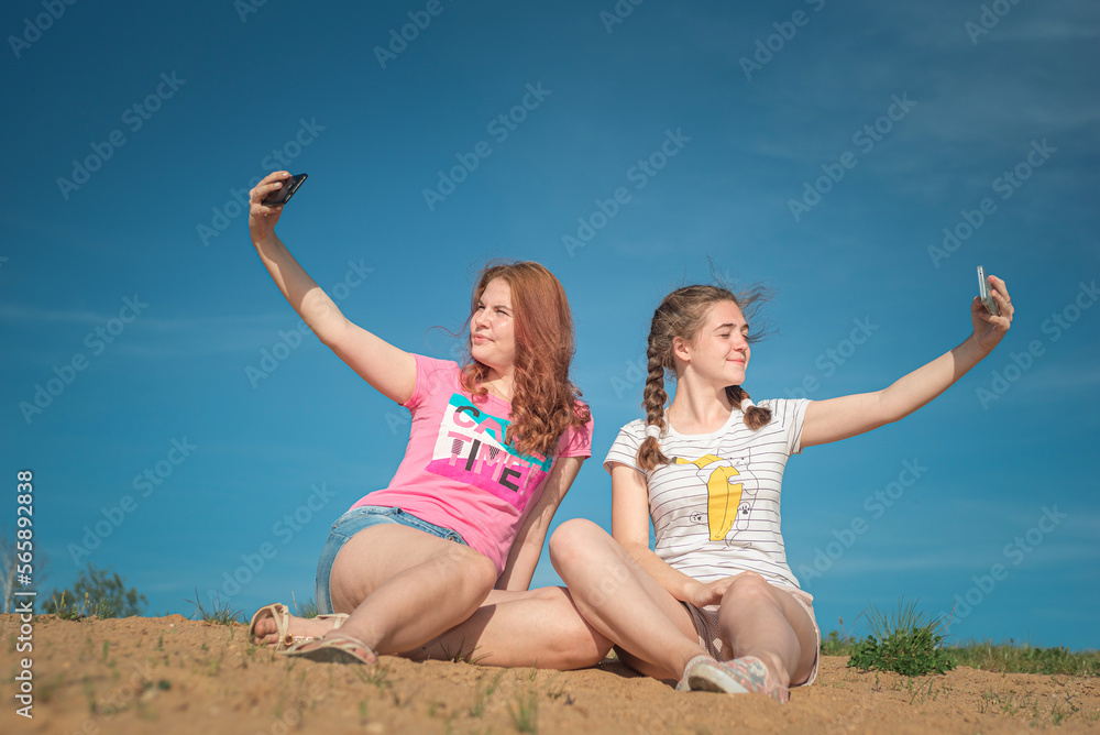 Portrait of young beautiful two girlfriends in summer outdoors. Portrait of young beautiful two girlfriends in summer outdoors.