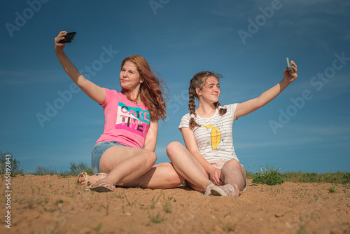 Portrait of young beautiful two girlfriends in summer outdoors.