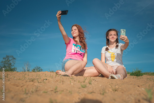 Portrait of young beautiful two girlfriends in summer outdoors.