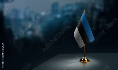 Small flags of the Estonia on an abstract blurry background