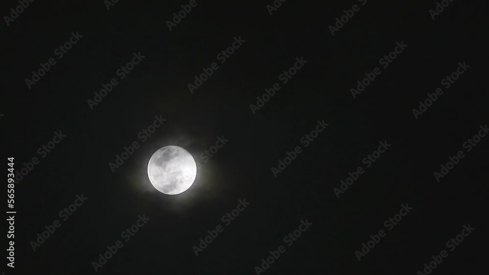 Full Corn Planting Moon shiny on the dark night cloud with cloud passing Full Corn Planting Moon shiny on the dark night cloud with cloud passing