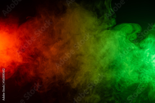 Red yellow green smoke on a black background.