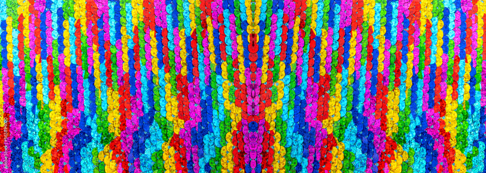Texture of rainbow shiny sequins. Fashionable bright fabric with sequins.