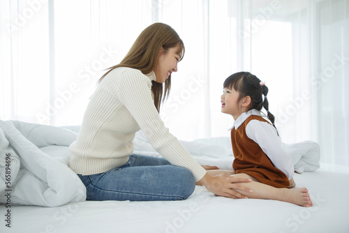 Happy loving family. Asian mother and her daughter child girl playing in bedroom.