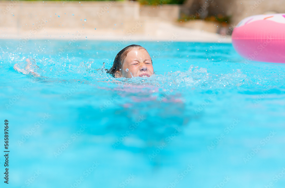 little girl deftly swim underwater in pool