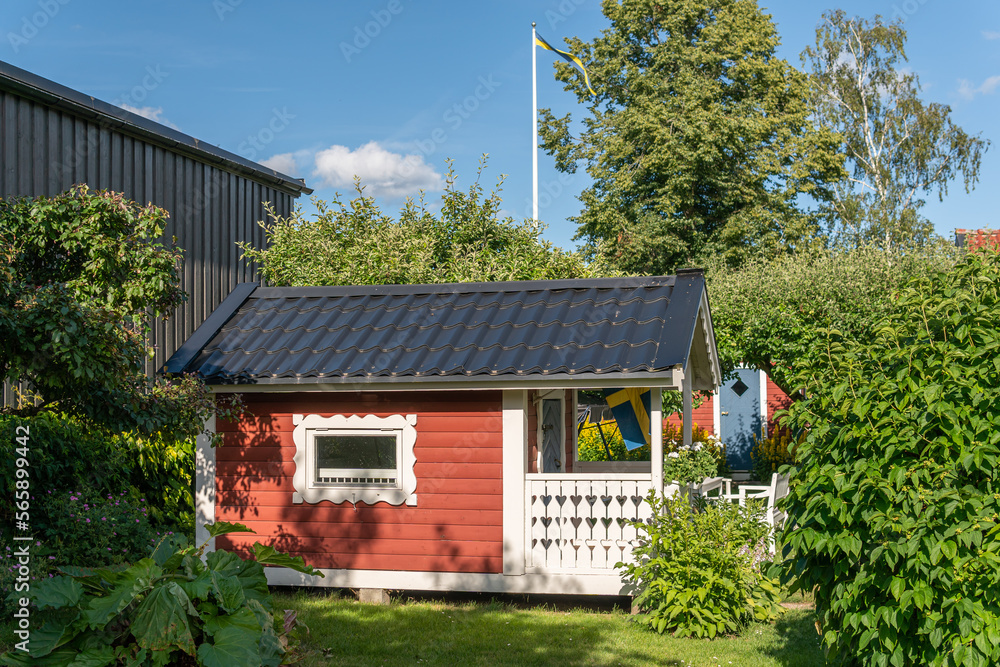 Traditional old vintage red Swedish house from wood on a sunny day in summer