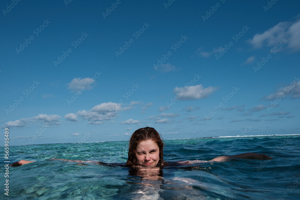 Smiling portrait of beautiful woman in the ocean