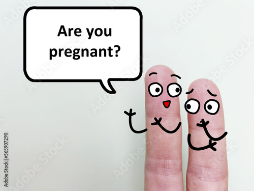 Two fingers are decorated as two person. One of them is asking another if she is pregnant.