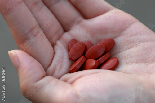 Iron supplement tablets in woman   s hand. for treat iron deficiency anemia.