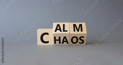 Calm vs chaos symbol. Turned wooden cubes with words Chaos and Calm. Beautiful grey background. Business and Calm vs chaos concept. Copy space. © Natallia