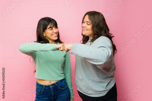 Photos Happy best friends doing a fist bump
