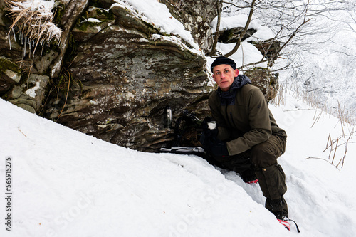 A man drinking coffee during a break on a mountain trip in winter. © Szymon Bartosz